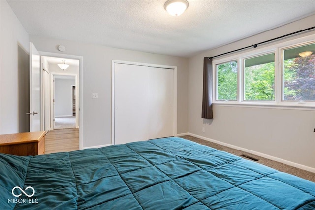 601 Woodbine, Terre Haute, IN 47803 - bedroom with carpet flooring, a closet, baseboards, and a textured ceiling