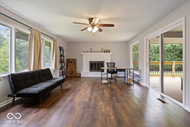 601 Woodbine, Terre Haute, IN 47803 - living room with a ceiling fan, dark wood-type flooring, plenty of natural light, and a textured ceiling