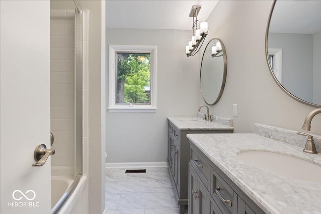 601 Woodbine, Terre Haute, IN 47803 - bathroom featuring two vanities, marble look tiles, shower / washtub combination, a textured ceiling, and toilet