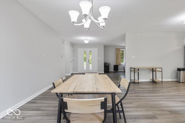 601 Woodbine, Terre Haute, IN 47803 - dining space featuring a chandelier, baseboards, wood finished floors, and french doors