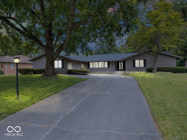 601 Woodbine, Terre Haute, IN 47803 - ranch-style home with driveway, a front lawn, board and batten siding, and an attached garage