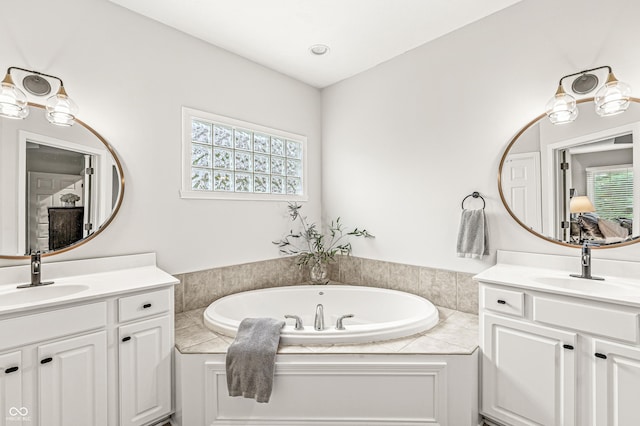 10697 Woodmont Ln, Fishers, IN 46037 - full bathroom with two vanities, a bath, and ensuite bathroom