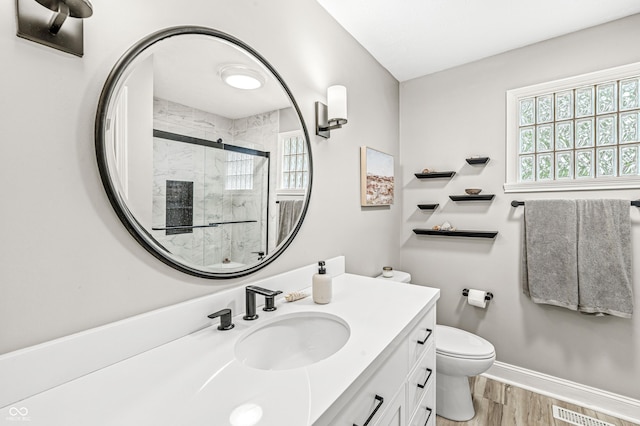 10697 Woodmont Ln, Fishers, IN 46037 - full bath featuring wood finished floors, vanity, a stall shower, toilet, and baseboards