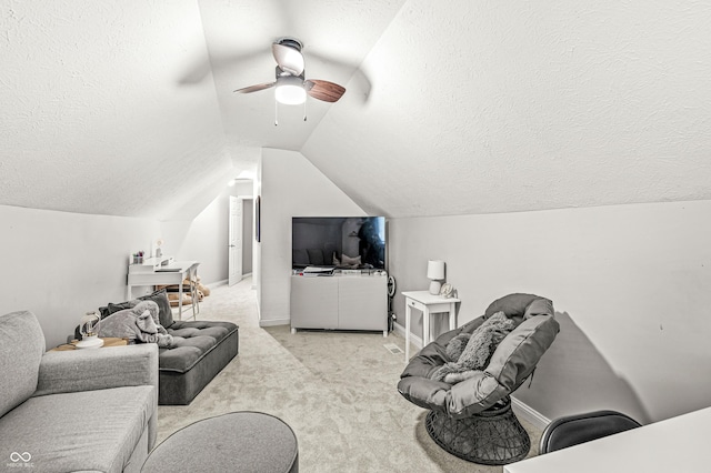 10697 Woodmont Ln, Fishers, IN 46037 - carpeted living area with a textured ceiling, a ceiling fan, lofted ceiling, and baseboards