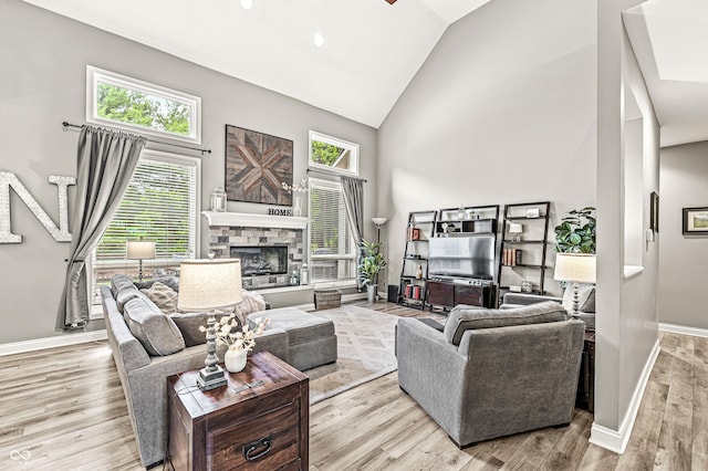 10697 Woodmont Ln, Fishers, IN 46037 - living room featuring high vaulted ceiling, wood finished floors, baseboards, a fireplace, and recessed lighting