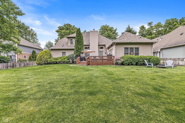 10697 Woodmont Ln, Fishers, IN 46037 - rear view of house featuring a wooden deck, a chimney, and roof with shingles