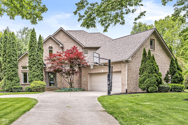 10697 Woodmont Ln, Fishers, IN 46037 - view of front of house with a front lawn, concrete driveway, brick siding, and a shingled roof