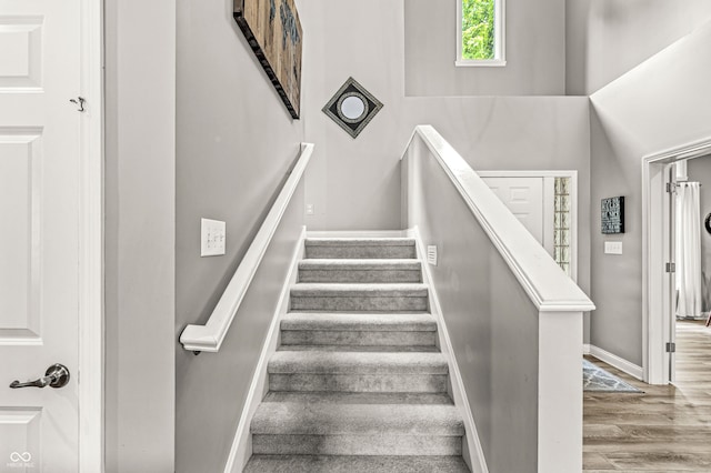 10697 Woodmont Ln, Fishers, IN 46037 - stairway featuring baseboards and wood finished floors