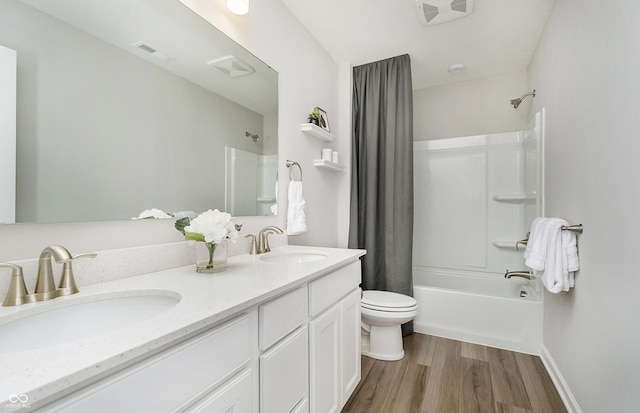 6849 Seabiscuit Rd, Whitestown, IN 46075 - full bath featuring shower / bath combo, double vanity, toilet, and wood finished floors
