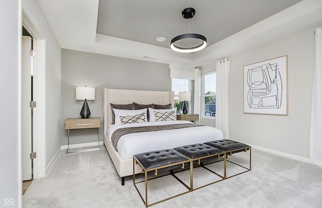6849 Seabiscuit Rd, Whitestown, IN 46075 - bedroom featuring baseboards, a raised ceiling, and light carpet