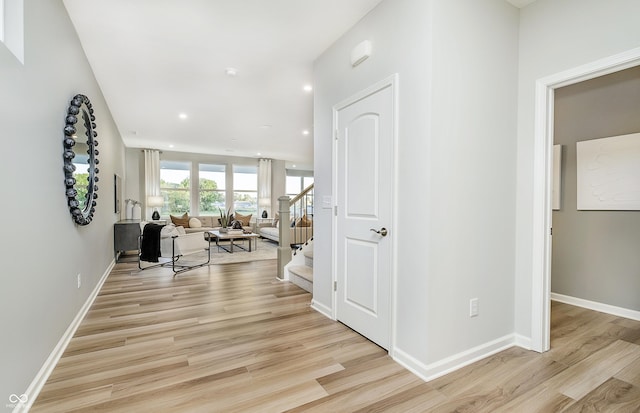 6849 Seabiscuit Rd, Whitestown, IN 46075 - corridor featuring light wood finished floors, stairway, baseboards, and recessed lighting