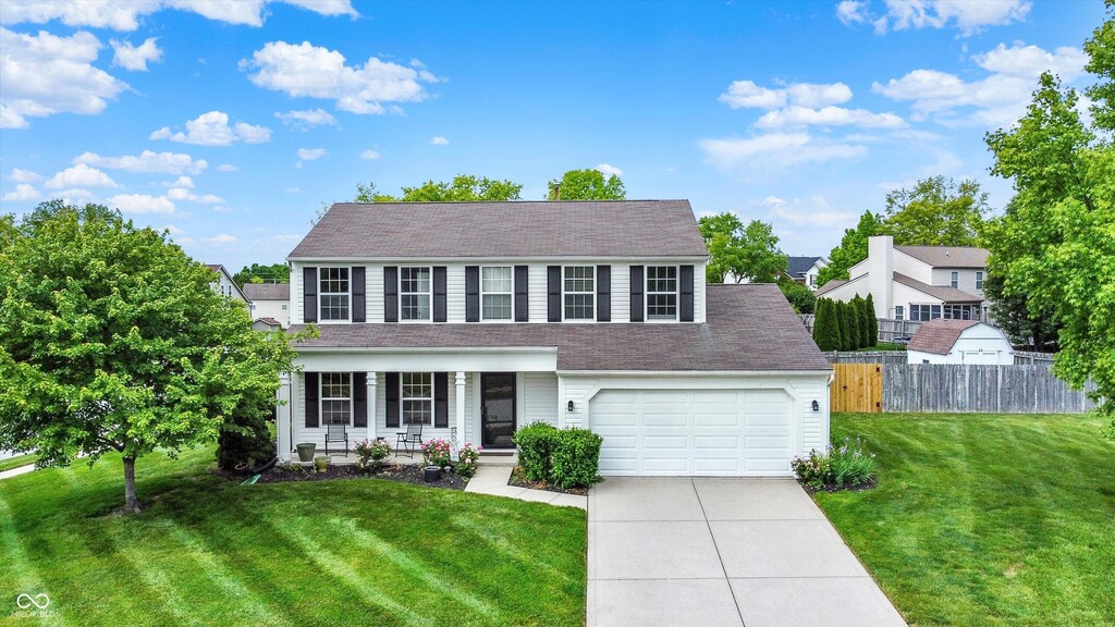 1234 Breaside Cir, Greenwood, IN 46143 - view of front of home with driveway, an attached garage, and a porch