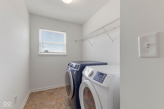 11531 Short Iron Ln, Indianapolis, IN 46235 - washroom with washing machine and clothes dryer, baseboards, and stone finish floors
