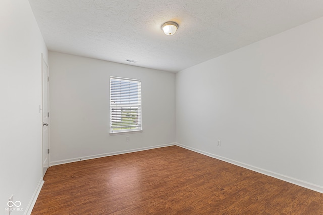 11531 Short Iron Ln, Indianapolis, IN 46235 - empty room featuring wood finished floors, baseboards, and a textured ceiling