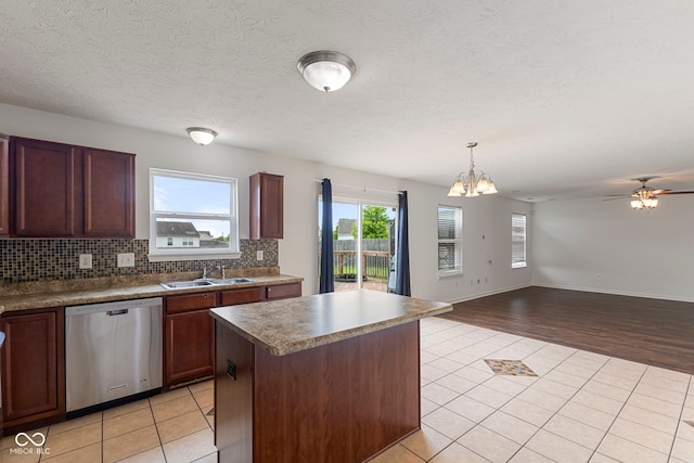 11531 Short Iron Ln, Indianapolis, IN 46235 - kitchen featuring dishwasher, a sink, light tile patterned floors, a chandelier, and decorative backsplash