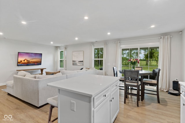 7051 E Bean Blossom Dr, Camby, IN 46113 - kitchen featuring recessed lighting, light wood finished floors, light countertops, a kitchen island, and white cabinets