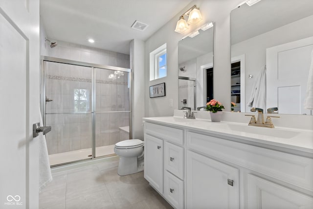 7051 E Bean Blossom Dr, Camby, IN 46113 - bathroom with double vanity, toilet, a stall shower, and tile patterned flooring