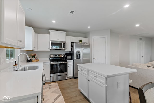 7051 E Bean Blossom Dr, Camby, IN 46113 - kitchen with stainless steel appliances, a sink, recessed lighting, white cabinetry, and open floor plan