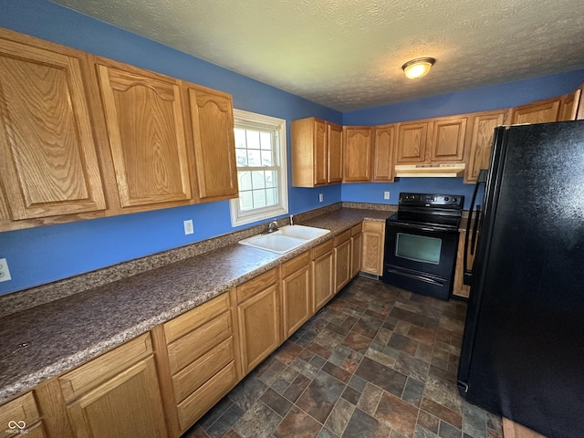 2133 10th St, Columbus, IN 47201 - kitchen with black appliances, a sink, under cabinet range hood, dark stone finish floors, and dark countertops