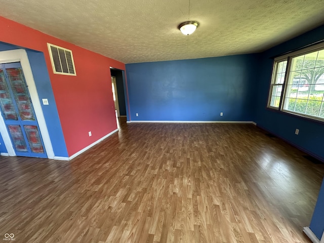 2133 10th St, Columbus, IN 47201 - unfurnished room featuring wood finished floors, a textured ceiling, and baseboards