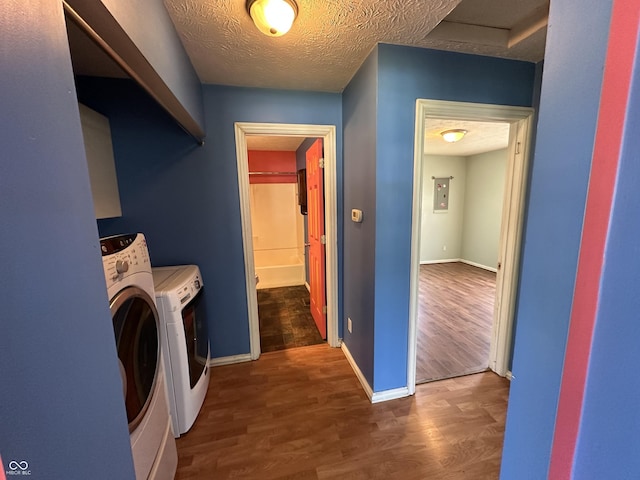 2133 10th St, Columbus, IN 47201 - washroom with washing machine and dryer, wood finished floors, baseboards, electric panel, and a textured ceiling