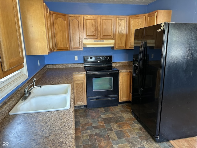 2133 10th St, Columbus, IN 47201 - kitchen with black appliances, under cabinet range hood, a sink, and dark stone finish floors