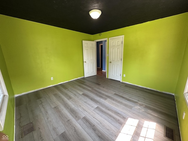 2133 10th St, Columbus, IN 47201 - unfurnished bedroom featuring wood finished floors and baseboards