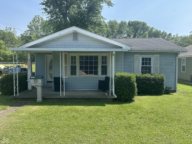 2133 10th St, Columbus, IN 47201 - view of front of house with covered porch and a front lawn