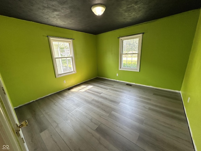 2133 10th St, Columbus, IN 47201 - unfurnished room featuring plenty of natural light, baseboards, and wood finished floors