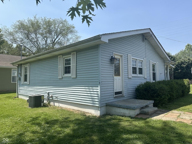 2133 10th St, Columbus, IN 47201 - view of home's exterior with central AC and a yard