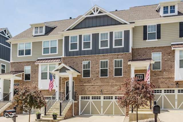 16072 Barringer Ct, Westfield, IN 46074 - townhome / multi-family property featuring an attached garage, driveway, board and batten siding, brick siding, and roof with shingles