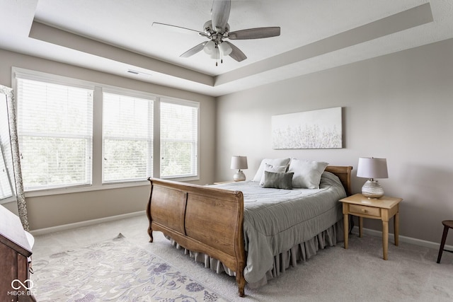 16072 Barringer Ct, Westfield, IN 46074 - bedroom with light colored carpet, a raised ceiling, and ceiling fan