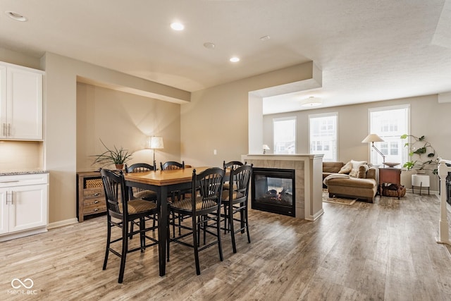 16072 Barringer Ct, Westfield, IN 46074 - dining room featuring light wood-style floors, recessed lighting, and a tile fireplace