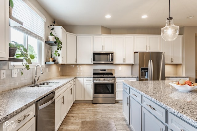 16072 Barringer Ct, Westfield, IN 46074 - kitchen with stainless steel appliances, plenty of natural light, light wood-type flooring, white cabinetry, and recessed lighting