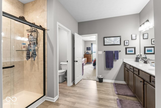 104 Perlican Dr, Cicero, IN 46034 - ensuite bathroom featuring toilet, wood finished floors, double vanity, and a shower stall