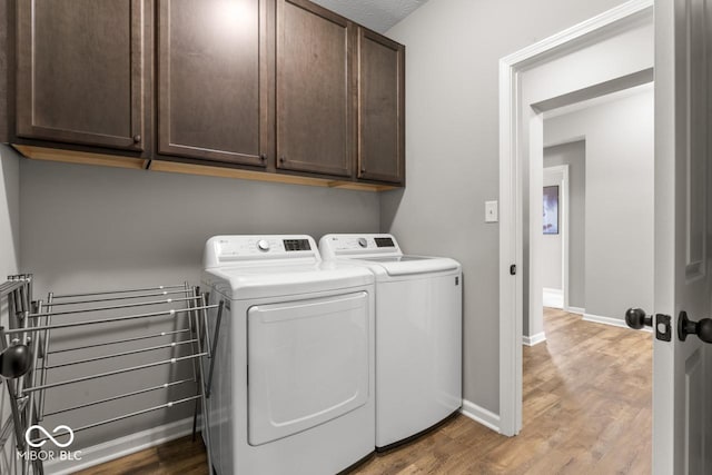104 Perlican Dr, Cicero, IN 46034 - washroom featuring independent washer and dryer, cabinet space, wood finished floors, and baseboards