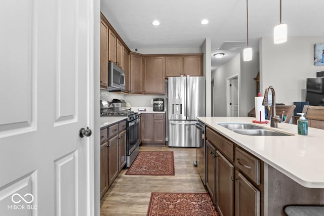 104 Perlican Dr, Cicero, IN 46034 - kitchen with appliances with stainless steel finishes, a sink, light wood-style flooring, light countertops, and recessed lighting