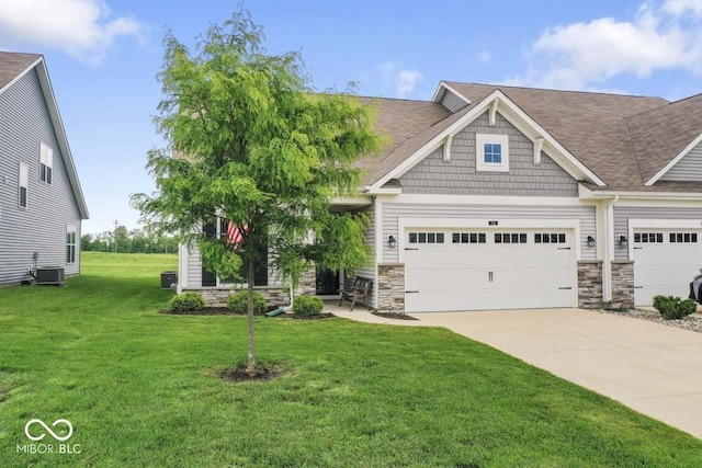 104 Perlican Dr, Cicero, IN 46034 - craftsman inspired home with driveway, a front lawn, stone siding, central air condition unit, and a shingled roof