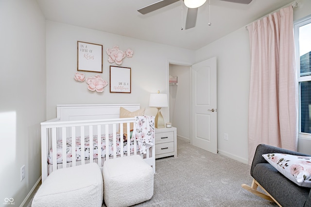 6841 Seabiscuit Rd, Whitestown, IN 46075 - carpeted bedroom featuring a crib, ceiling fan, and baseboards
