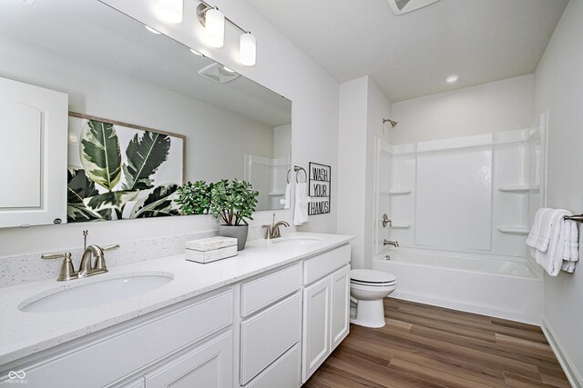 6841 Seabiscuit Rd, Whitestown, IN 46075 - bathroom with double vanity, toilet, shower / bathtub combination, wood finished floors, and recessed lighting