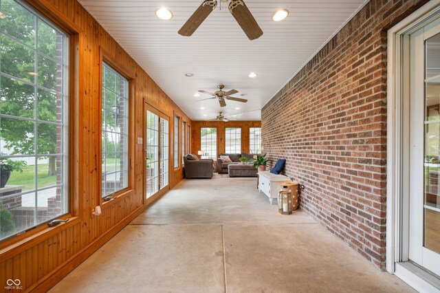 2708 N 400 E, Greenfield, IN 46140 - sunroom / solarium with a ceiling fan, brick wall, an outdoor living space, concrete floors, and wood walls