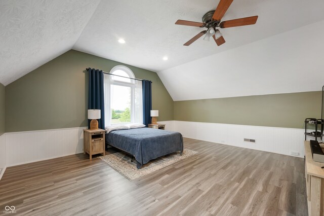 2708 N 400 E, Greenfield, IN 46140 - bedroom with wainscoting, vaulted ceiling, wood finished floors, and a ceiling fan
