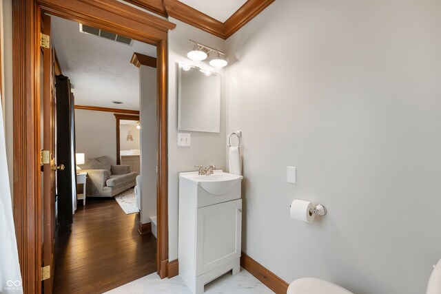 2708 N 400 E, Greenfield, IN 46140 - half bathroom with crown molding, vanity, baseboards, toilet, and marble finish flooring