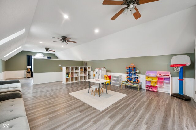 2708 N 400 E, Greenfield, IN 46140 - game room with ceiling fan, vaulted ceiling, wood finished floors, a skylight, and wainscoting