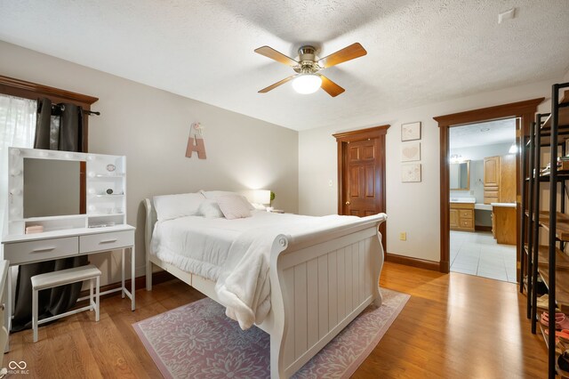 2708 N 400 E, Greenfield, IN 46140 - bedroom with light wood-type flooring, ceiling fan, baseboards, and ensuite bath