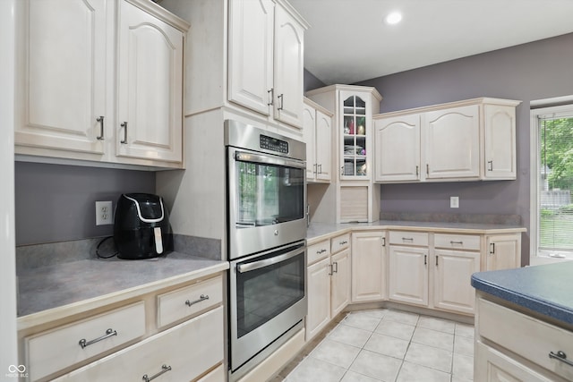 7138 Nile Ridge Ct, Indianapolis, IN 46236 - kitchen featuring double oven, light tile patterned flooring, glass insert cabinets, and recessed lighting
