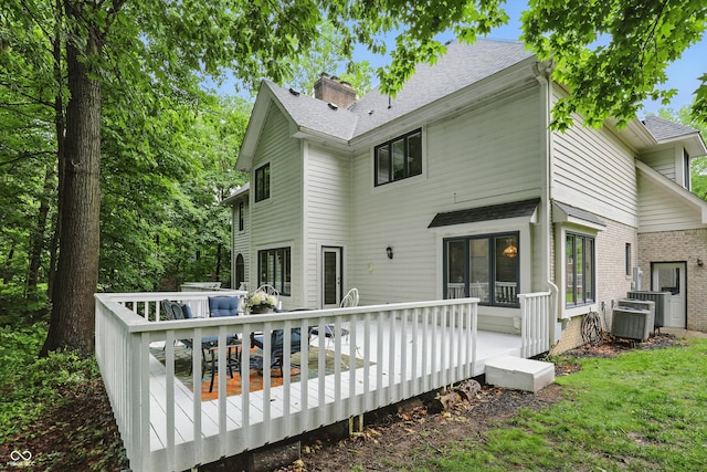 7138 Nile Ridge Ct, Indianapolis, IN 46236 - rear view of property featuring a wooden deck, roof with shingles, a chimney, and central AC