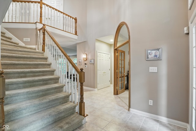 7138 Nile Ridge Ct, Indianapolis, IN 46236 - stairs featuring baseboards, a towering ceiling, and tile patterned flooring