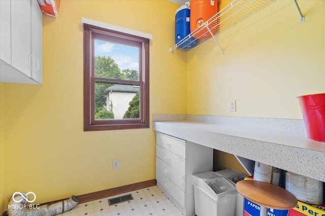 6363 Harmonridge Ct, Indianapolis, IN 46278 - washroom featuring light flooring, baseboards, washer and clothes dryer, and cabinet space