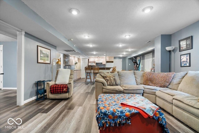 6363 Harmonridge Ct, Indianapolis, IN 46278 - living room featuring wood finished floors, a textured ceiling, and baseboards